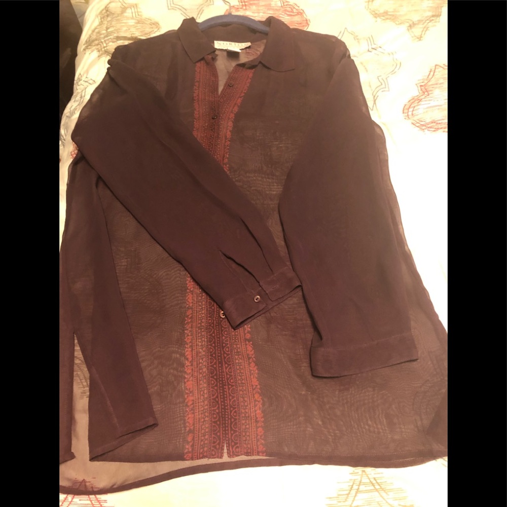 Woman’s button down sheer blouse. Deep wine with flower design in front.